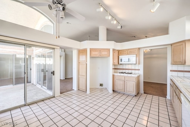 kitchen featuring tile counters, light brown cabinets, ceiling fan, and white appliances