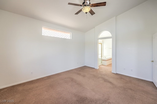 spare room featuring light carpet, a healthy amount of sunlight, ceiling fan, and high vaulted ceiling