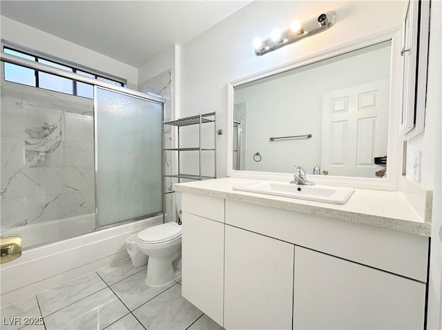 full bathroom featuring toilet, vanity, and combined bath / shower with glass door