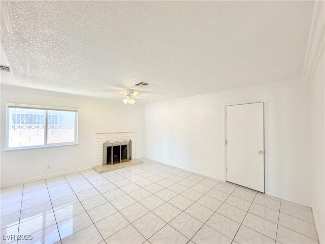 unfurnished living room featuring a brick fireplace, a textured ceiling, ceiling fan, and light tile patterned flooring