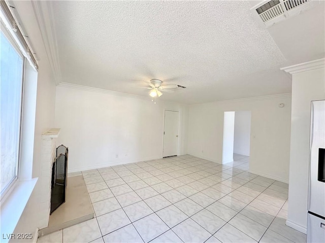 unfurnished living room with ceiling fan, plenty of natural light, a textured ceiling, and light tile patterned floors