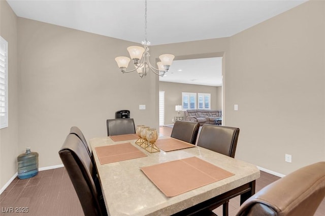 dining space with an inviting chandelier