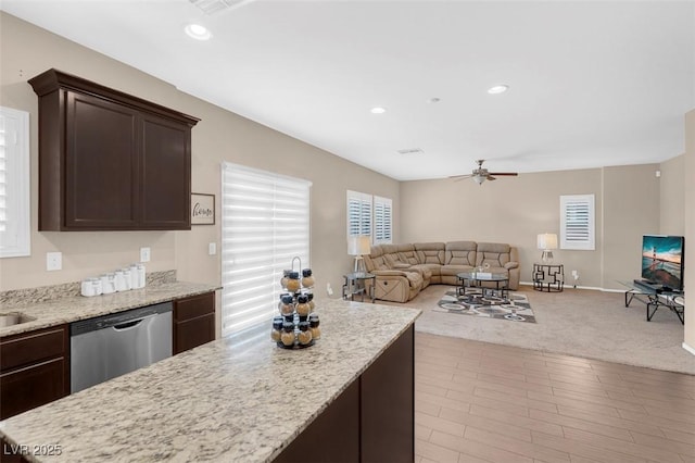 kitchen with ceiling fan, dishwasher, light stone counters, and dark brown cabinetry