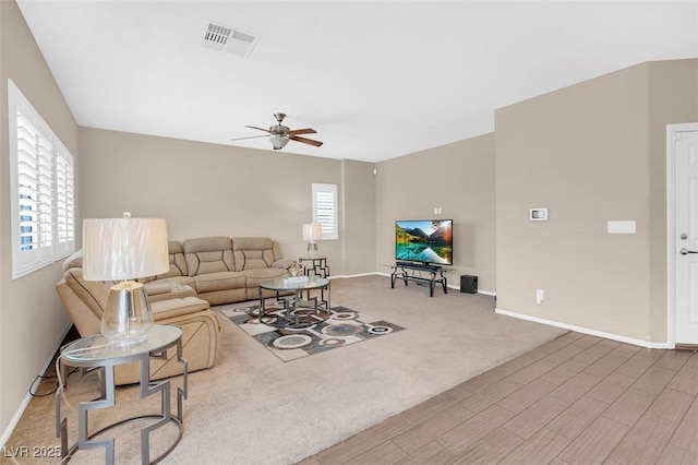 living room featuring ceiling fan, plenty of natural light, and hardwood / wood-style floors