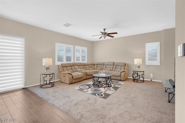 living room featuring ceiling fan and wood-type flooring