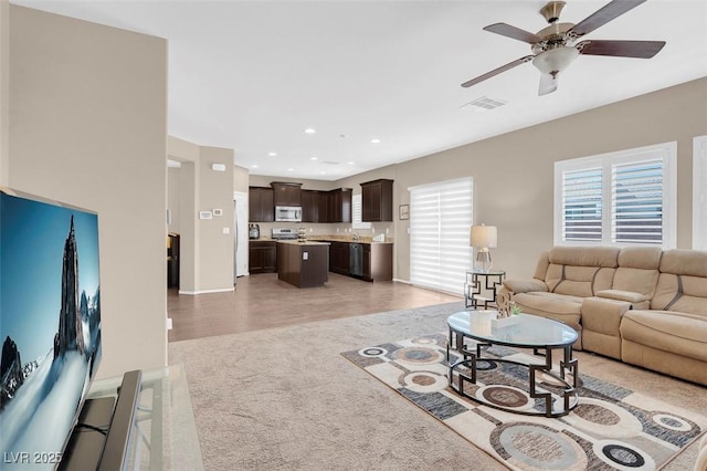 living room with ceiling fan and hardwood / wood-style floors