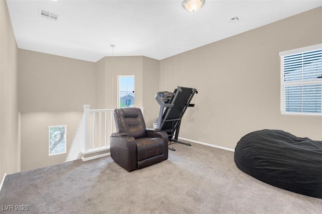 living area featuring light carpet