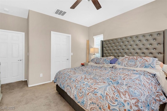 bedroom featuring light carpet and ceiling fan