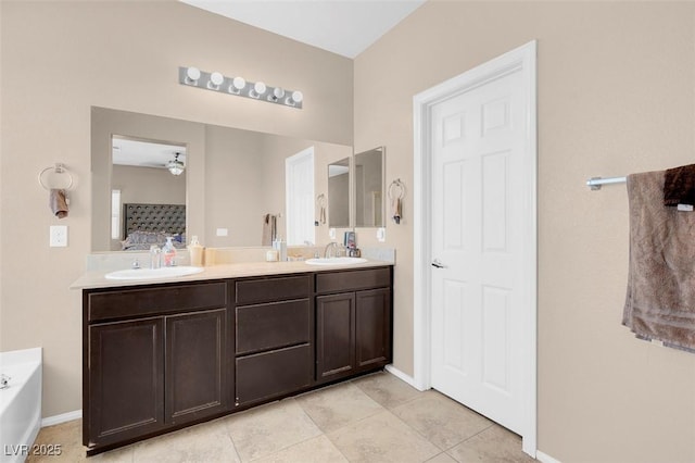 bathroom featuring ceiling fan, vanity, tile patterned flooring, and a washtub