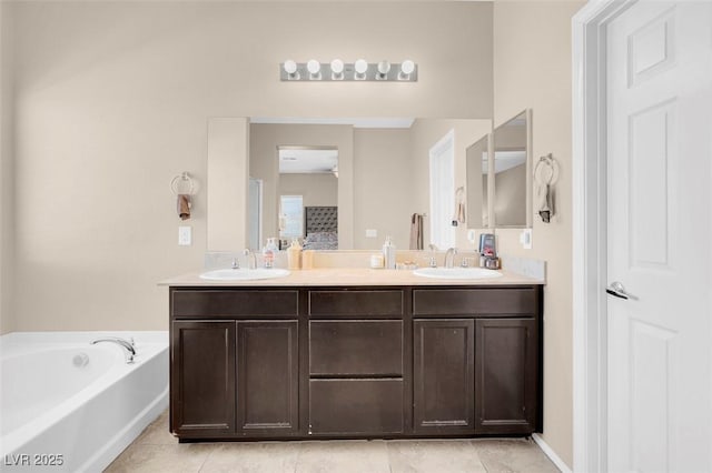 bathroom featuring tile patterned floors, a tub to relax in, and vanity