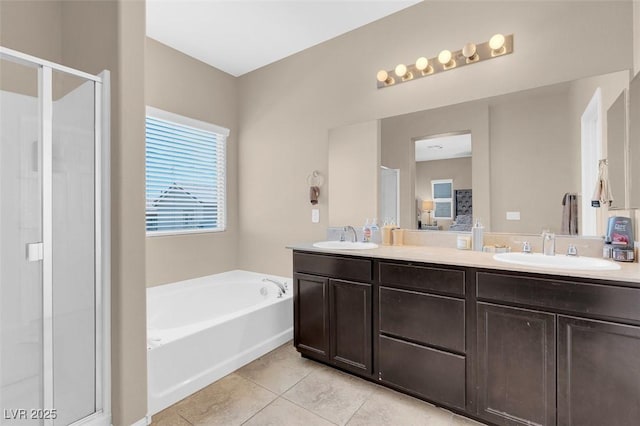 bathroom featuring tile patterned floors, vanity, and shower with separate bathtub