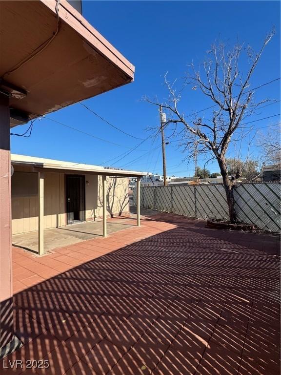 wooden terrace with a patio