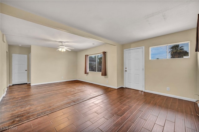 unfurnished room featuring beamed ceiling, dark hardwood / wood-style floors, and ceiling fan