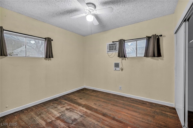 unfurnished room featuring ceiling fan, dark wood-type flooring, and a textured ceiling