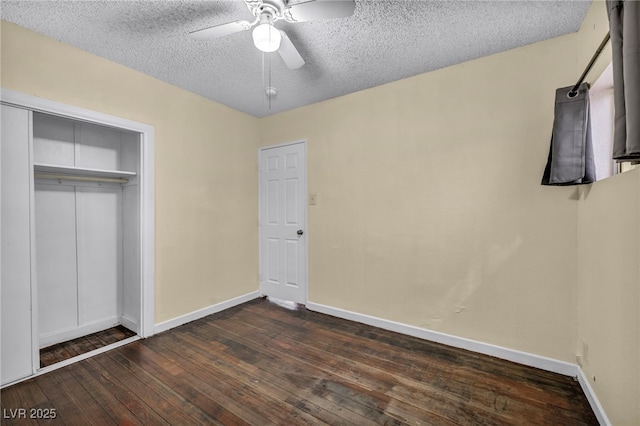 unfurnished bedroom with ceiling fan, dark hardwood / wood-style floors, a textured ceiling, and a closet