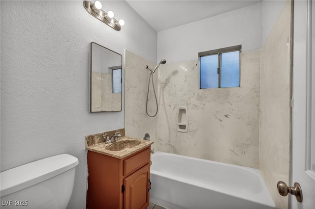 full bathroom with toilet, vanity, and tiled shower / bath