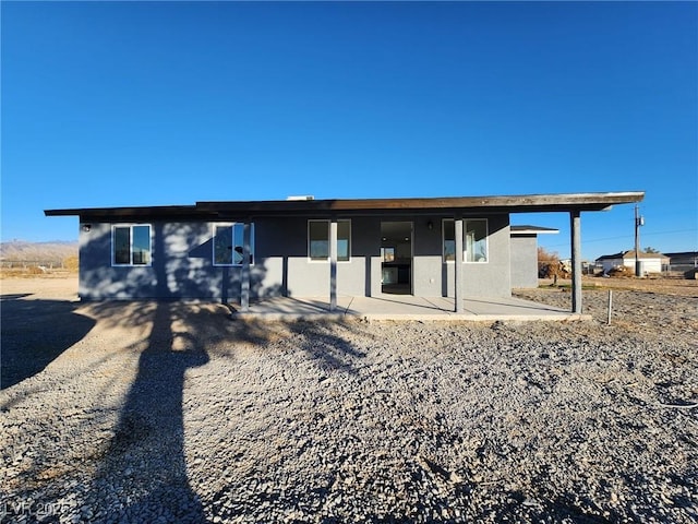 rear view of property featuring a patio