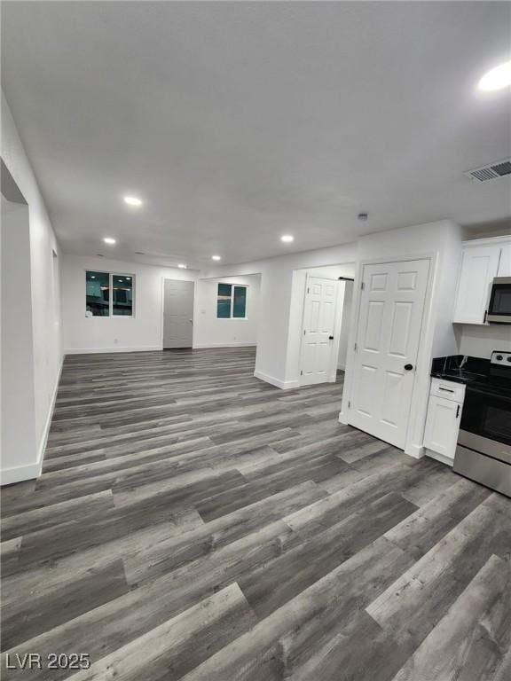 unfurnished living room with dark wood-type flooring