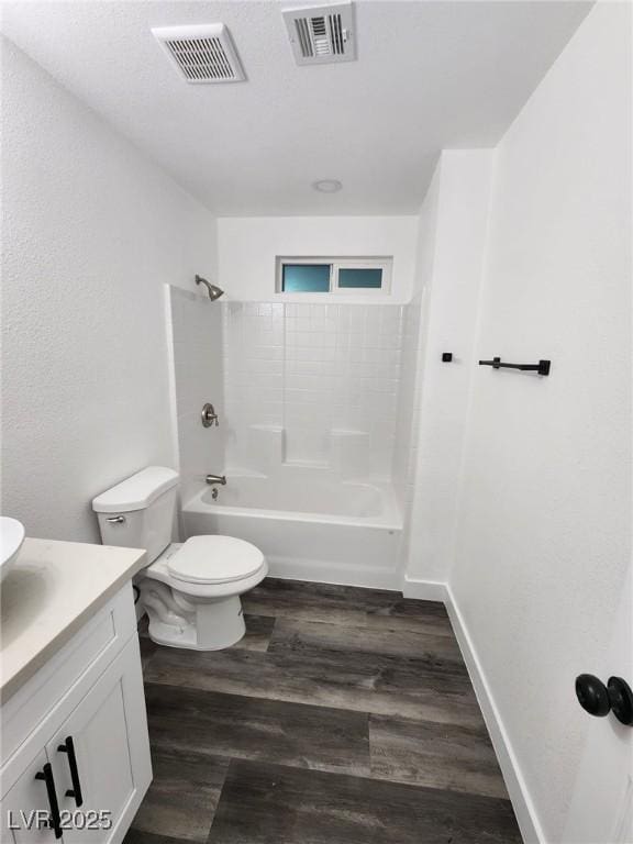 full bathroom with tub / shower combination, wood-type flooring, toilet, and vanity