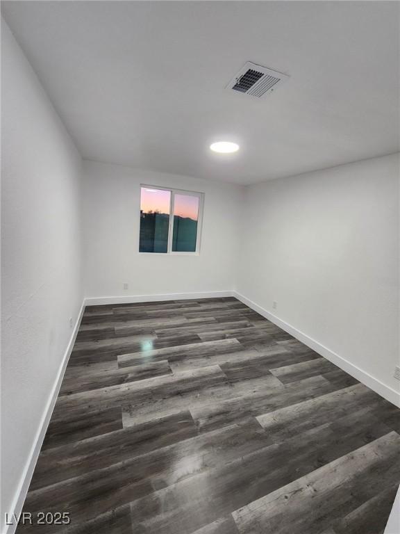 spare room featuring dark hardwood / wood-style flooring