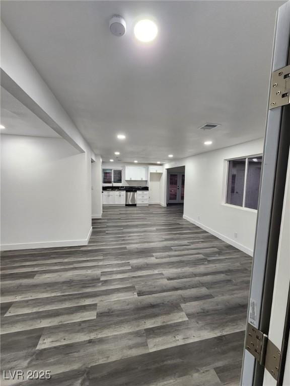 unfurnished living room with dark wood-type flooring