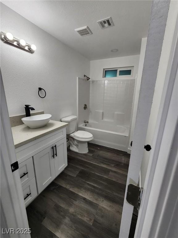 full bathroom with shower / bathing tub combination, vanity, toilet, and hardwood / wood-style floors