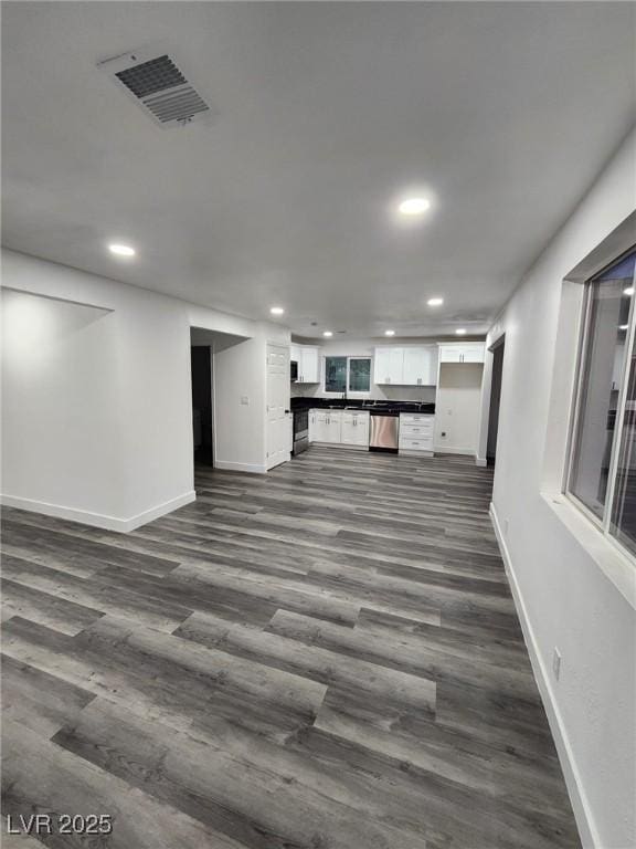 unfurnished living room with dark hardwood / wood-style floors