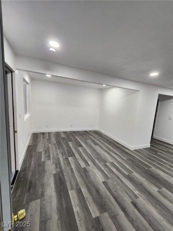 basement with dark hardwood / wood-style floors