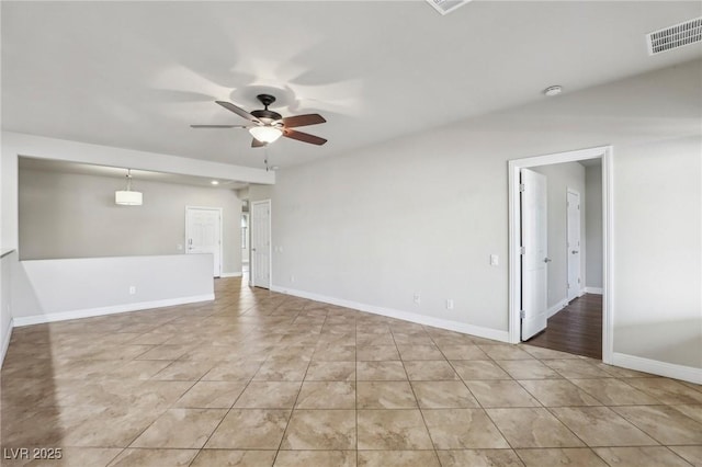 spare room with ceiling fan, visible vents, baseboards, and light tile patterned flooring