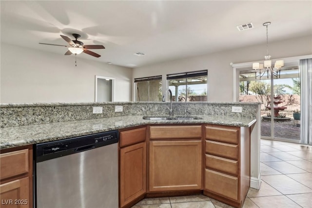 kitchen featuring visible vents, light stone counters, brown cabinets, stainless steel dishwasher, and a sink