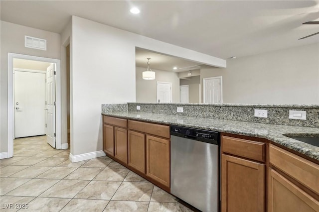 kitchen featuring light stone counters, brown cabinetry, visible vents, and stainless steel dishwasher