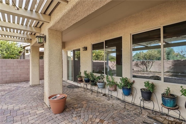 view of patio featuring fence and a pergola