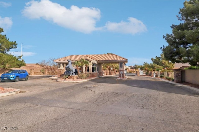 mediterranean / spanish house with a gate and a tile roof