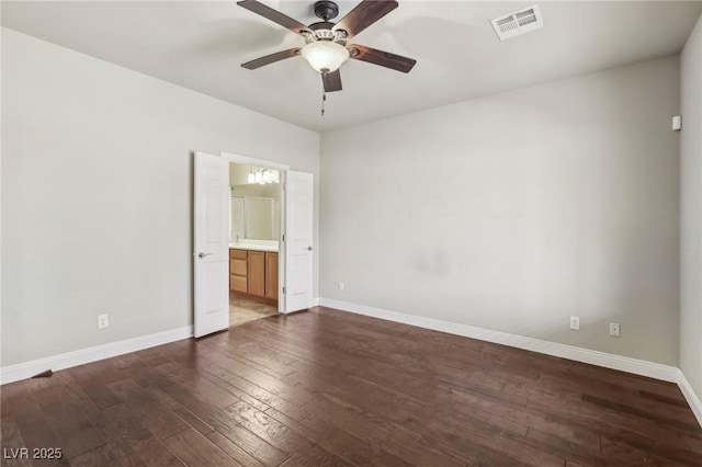 unfurnished bedroom featuring visible vents, dark wood finished floors, and baseboards