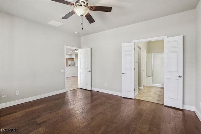 unfurnished bedroom with a ceiling fan, visible vents, baseboards, and wood finished floors