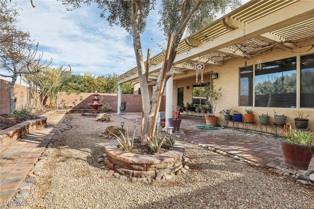 view of yard featuring a patio, fence, and a pergola