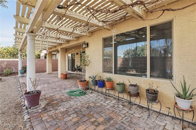 view of patio / terrace with fence and a pergola