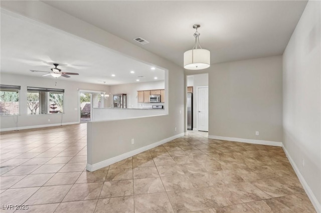 unfurnished room featuring light tile patterned floors, visible vents, and baseboards