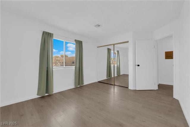 empty room with hardwood / wood-style floors