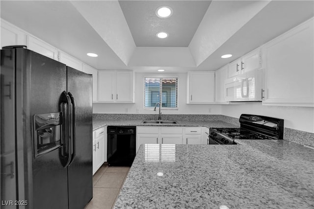 kitchen featuring sink, white cabinetry, black appliances, and a raised ceiling