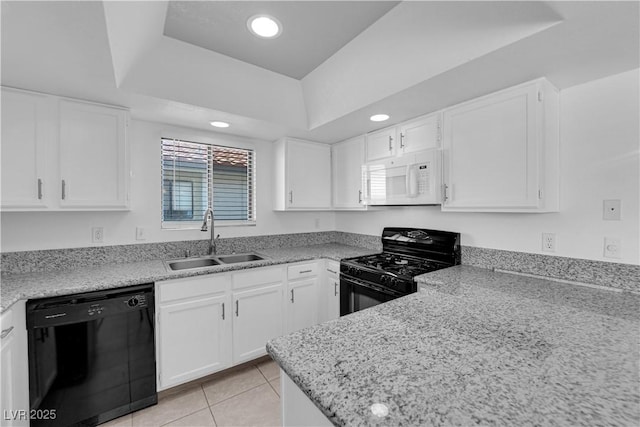 kitchen with light tile patterned floors, a raised ceiling, black appliances, white cabinets, and sink