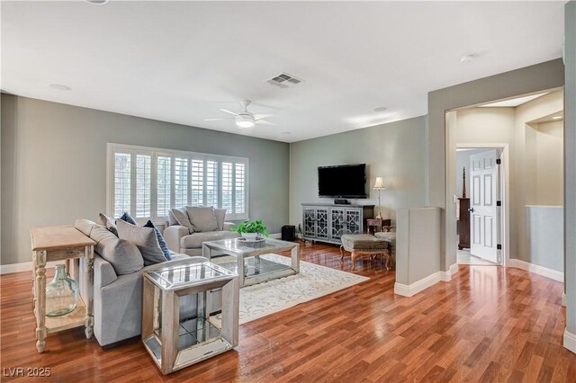 living room with hardwood / wood-style flooring and ceiling fan