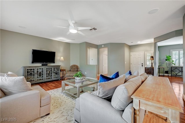 living room featuring ceiling fan and light wood-type flooring