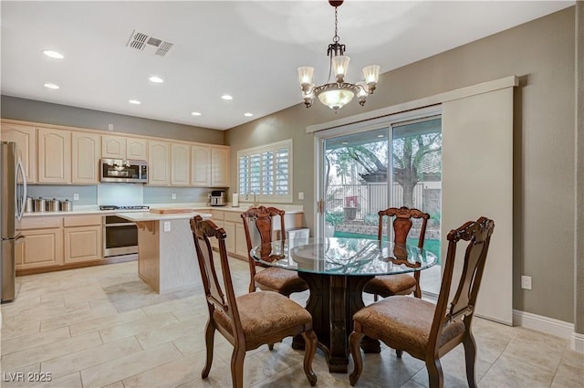 dining area featuring a notable chandelier