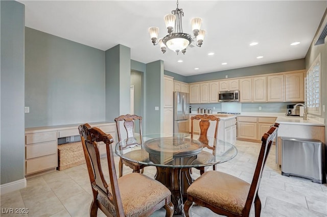 dining room with sink, light tile patterned floors, and a notable chandelier