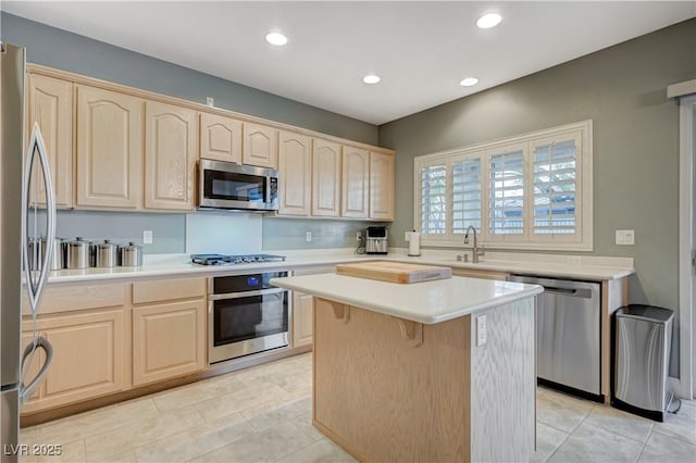 kitchen with a kitchen island, appliances with stainless steel finishes, light tile patterned floors, and light brown cabinetry