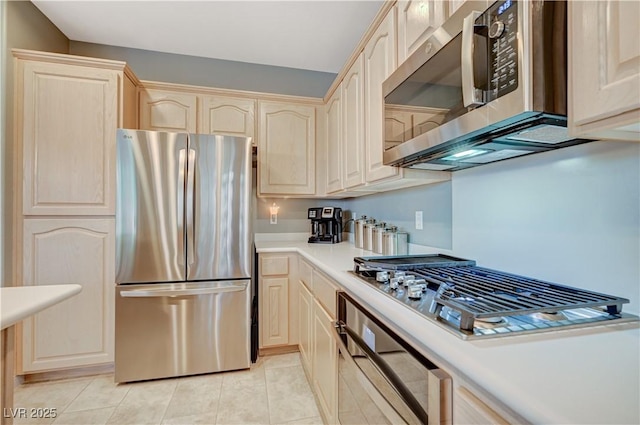 kitchen with appliances with stainless steel finishes, light brown cabinetry, and light tile patterned floors