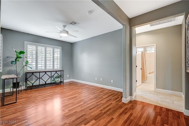 empty room featuring hardwood / wood-style floors and ceiling fan