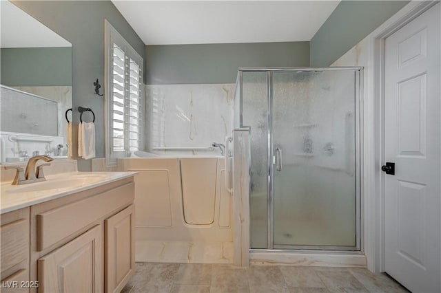 bathroom with vanity and independent shower and bath