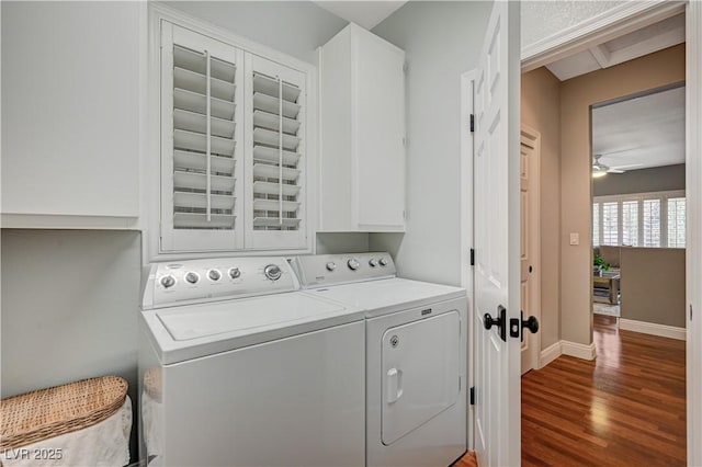 laundry area with cabinets, ceiling fan, dark wood-type flooring, and washer and clothes dryer